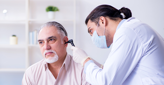 ENT specialist examining inner ear of patient